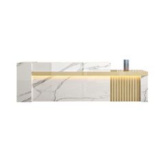 a white marble counter top with gold trimmings and an illuminated light above it