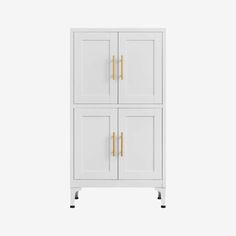 a white cabinet with two doors and gold handles on the front, against a white background