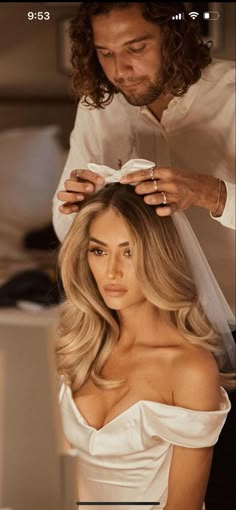 a woman getting her hair styled by a man