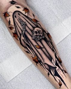 a man's leg with a tattoo on it and a skull in the middle