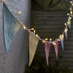 a string of lights hanging from a brick wall