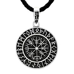 a black and white pendant with symbols on it