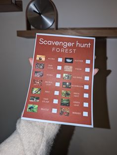 a person holding up a poster that says scavenger hunt forest