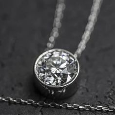 This pendant necklace features a solid 14k gold setting with a 1.2-1.35 carat round brilliant lab grown diamond. Choose a prong setting for maximum sparkle or a bezel setting for security and a more vintage look. Diamond Details: 1.20-1.35 Carats G+ Color VS2+ Clarity Necklace Details: Solid 14K gold in your choice of yellow or white 18" Stock reflects what we have available for on-time Christmas delivery. If you do not need your order by Christmas, please e-mail us. Elegant Pendant Diamond Necklace With Prong Setting, Dazzling Round Cut Necklace With Bezel Setting, Luxury Necklace With Smooth Bezel Round Pendant, 14k Gold Necklace With Prong-set Round Pendant, Luxury Bezel-set Solitaire Round Cut Necklace, Gem Diamonds, Retro Jewelry, Band Bracelet, Diamond Pendant Necklace