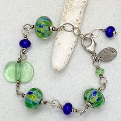 Bracelet: Lime and Blue Handmade Artisan Glass – Bluemangroveart Handmade Blue Sterling Silver Beaded Bracelets, Adjustable Blue Jewelry With Recycled Glass, Handmade Beaded Bracelets In Sterling Silver With Fusion Style, Adjustable Blue Jewelry Made Of Recycled Glass, Adjustable Blue Recycled Glass Jewelry, Adjustable Glass Beaded Bracelets Nickel Free, Artistic Blue Czech Glass Jewelry, Blue Czech Glass Beaded Bracelets With Lobster Clasp, Blue Beaded Bracelets With Lobster Clasp In Czech Glass