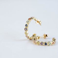 Rainbow sapphire hoop earring in 14K solid gold in bezel setting. Unique eternity solid gold hoops for women. The best birthday gift for her!100% handcrafted with love!PRODUCT DETAILS• Metal: 14K solid gold, 14K white gold or 14K rose gold• Gemstone: 26 Sapphires, Round cut• Sapphires' Weight: 0.97ct totalHOW TO ORDER - CUSTOM ORDERS• Choose from the drop-down menus the available options (Material) and leave us a note for any special requirements.• For special orders (if you wish the ring to mat Gold Multi-stone Hoop Earrings As A Gift, Elegant Rainbow Hoop Earrings, Yellow Gold Multi-stone Hoop Earrings Fine Jewelry, Multicolor Multi-stone Hoop Jewelry, Sapphire Hoop Earrings, 14k Gold Multi-stone Rainbow Jewelry, Gold For Women, Best Birthday Gift, Birthstone Stacking Rings