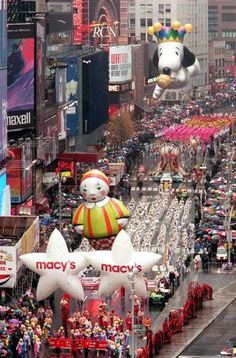 macy's balloon floats down the street during a parade