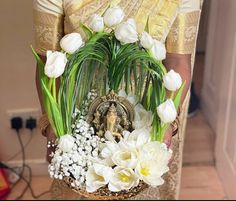 a woman holding a basket with flowers in it