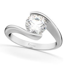 a white gold ring with a round diamond in the center and a curved band around it