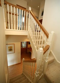 the stairs in this house are white and wood