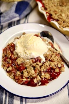 a white plate topped with fruit and ice cream next to a bowl of desserts