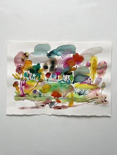 a piece of paper that has been painted with watercolors and ink on it