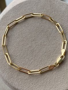 Statement piece for your wrist stack. Features oval-shaped elongated paper link design. Handcrafted in 14K Gold. This beauty is perfect for layering! Makes the perfect gift that will last a life time! 7 inches Solid 14K Gold. 5.5 grams. All our items have been fully inspected for authenticity and condition by a GIA Graduate Gemologist. To see more carefully selected Vintage Bracelets and Watches from Gold Adore, please visit: https://www.etsy.com/shop/GoldAdore?section_id=10797490&ref=shopse Luxury Paperclip Bracelet With Oval Links, Luxury Gold Chain Link Paperclip Bracelet, Luxury Paperclip Chain Link Bracelet As Gift, Luxury Paperclip Chain Link Bracelet For Gift, Luxury Paperclip Bracelet With Oval Link For Everyday, Modern Gold Bracelet With Oval Cable Chain, Modern Oval Gold Bracelet For Everyday, Luxury Gold Chain Paperclip Bracelet For Everyday, Luxury Oval Link Paperclip Bracelet Gift