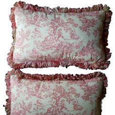 two pink and white pillows with ruffled edges