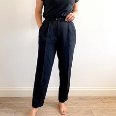 NEW, neat, smart vintage ladies trousers in jet black. They have a tapered leg, mid-high waist, front pleats and pockets, a skinny matching belt and it fastens with a zip and a button. The fabric polyester with Lycra so they have a slight stretch, are crease resistant and fall beautifully. A smart, flattering pair of trousers suitable for work or everyday wear. Made in the U.K. by St.Michael, in 1997. 98% polyester, 2% elastane Lycra. Medium size, labelled as 14UK/42EUR. Measurements when laid f Classic Tapered Pants With Belt Loops, Elegant Tapered Bottoms For Business Casual, Classic Tapered Bottoms For Workwear, Classic Tapered Formal Bottoms, Classic Workwear Bottoms With Belt Loops, Classic Bottoms With Belt Loops For Work, Fitted Tapered Workwear Pants, Classic Fitted Tapered Pants, Fitted Tapered Bottoms For Workwear