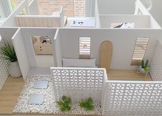 an aerial view of a model house with white walls and floors