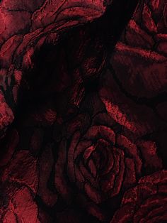 an image of red fabric with roses on it