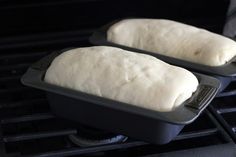 two loafs of bread sitting on top of an oven