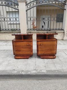 two wooden chests sitting next to each other on a sidewalk