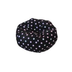 a black bean bag with pink and blue polka dots on the front, sitting against a white background