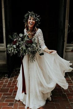 a woman wearing a white dress and holding a bouquet