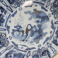 a blue and white plate with an image of a bird in the middle of it