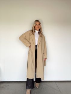 Experience elevated sophistication with this exclusive, lightweight trench coat. Featuring a collared neckline, waist tie detail, and wrap detail, this piece will be the perfect transition piece for any look. Whether you’re business-savvy shopping, dinner and drinks, or simply working from home, this luxe trench coat will be with you every step of the way. Its soft comfort and versatile style make it both trend-forward and timeless. 97% Polyester 3% Spandex Hand wash cold. Chic Outerwear For Work, Elegant Outerwear For Day Out In Fall, Elegant Fall Outerwear For Day Out, Elegant Outerwear For Fall Day Out, Belted Solid Outerwear For Work, Belted Solid Workwear Outerwear, Chic Solid Collared Outerwear, Chic Solid Color Collared Outerwear, Belted Long Sleeve Outerwear For Business Casual