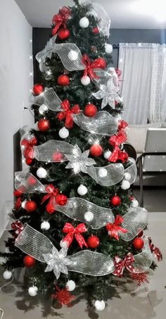 a christmas tree decorated with red and silver ornaments