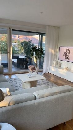 a living room filled with furniture and a large window