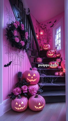 some pumpkins are sitting on the steps in front of stairs decorated with pink roses