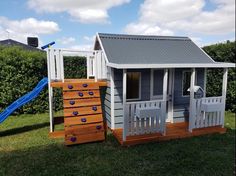 there is a small house with a slide in the yard