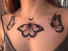 a woman's chest with three butterflies on it and the moon in the background