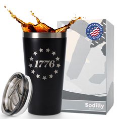 a black tumbler cup with an american flag on it next to a boxed box