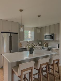 a kitchen with an island and three stools