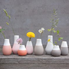 a group of vases sitting on top of a wooden table