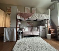 a loft bed with a couch underneath it in a room filled with furniture and decor