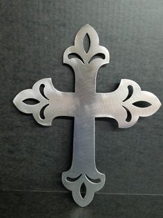 an ornate metal cross on a black surface