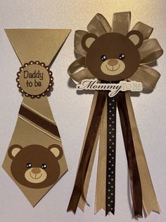 two brown teddy bears are on top of some ribbons and tags that say, daddy to be