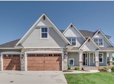 a large house with two garages in the front and one on the other side