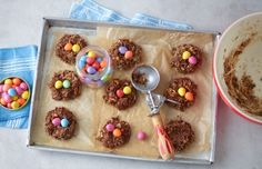 a tray with cookies and candy on it next to a bowl full of candies