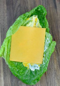 a piece of cheese on top of lettuce