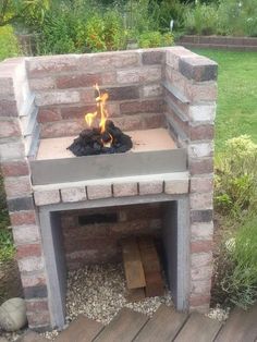 an outdoor fire pit made out of bricks