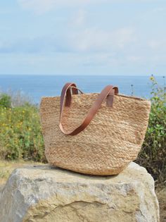 The Tutublue Medium Natural Jute Beach Bag with a leather strap is the perfect accessory for the beach! Throw in your beach towel, water, snacks, and all things sun, and enjoy your day in style. Dress it up or dress it down, either way, you'll turn heads and have fun! Jute Beach Bag, Beach Throw, Enjoy Your Day, Natural Jute, High Collar, Style Dress, Beach Bag, Beach Towel, Have Fun