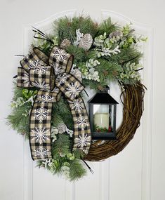 a christmas wreath with a lit candle on the front door