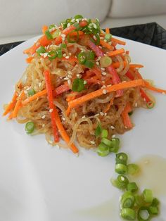 a white plate topped with noodles and veggies