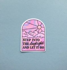 a pink sticker with the words step into the light and let it go on