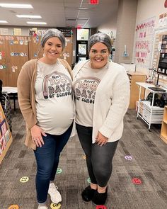 two pregnant women standing next to each other