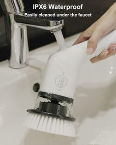 a person using a brush to clean a sink