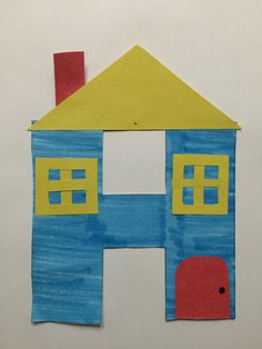 a child's drawing of a house made out of construction paper