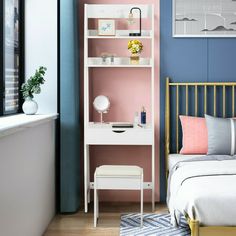 a bedroom with pink and blue walls, white furniture and a gold metal bed frame